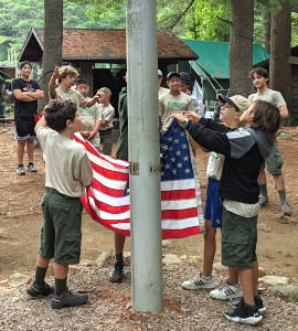 Scouts raising an American flag